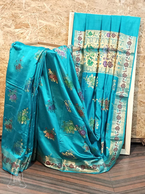Banarasi Chinia Silk Turquoise Blue Saree With Orange Green Purple Blue Resham flower motif And Zari Rose Boota Jangla Weave With Meenakari Work Heavy Zari Resham Meenakari Border And Anchal