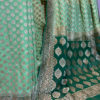 Banarasi Khaddi Georgette Light Green saree with small paisley copper zari boota Bottle Green border and anchal with heavy zari floral bel boota work