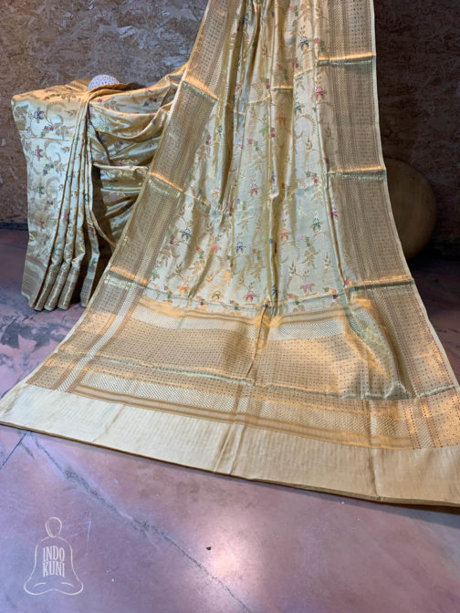 Banarasi Chinia Silk Off white saree with golden zari bel boota jangla weave all over with multi colored resham meenakari heavy zari work anchal and border with resham meenakari