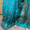 Banarasi Dupion Silk Acqua blue saree with orange pink green brown resham bel boota all over and in anchal with zari border in resham meenakari