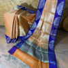 Banarasi Tanchoi Cotton saree with white Resham work on light orange base contrast royal blue border with white resham work and anchal with contrast grey base