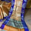 Banarasi Tanchoi Cotton saree with white Resham work on light orange base contrast royal blue border with white resham work and anchal with contrast grey base